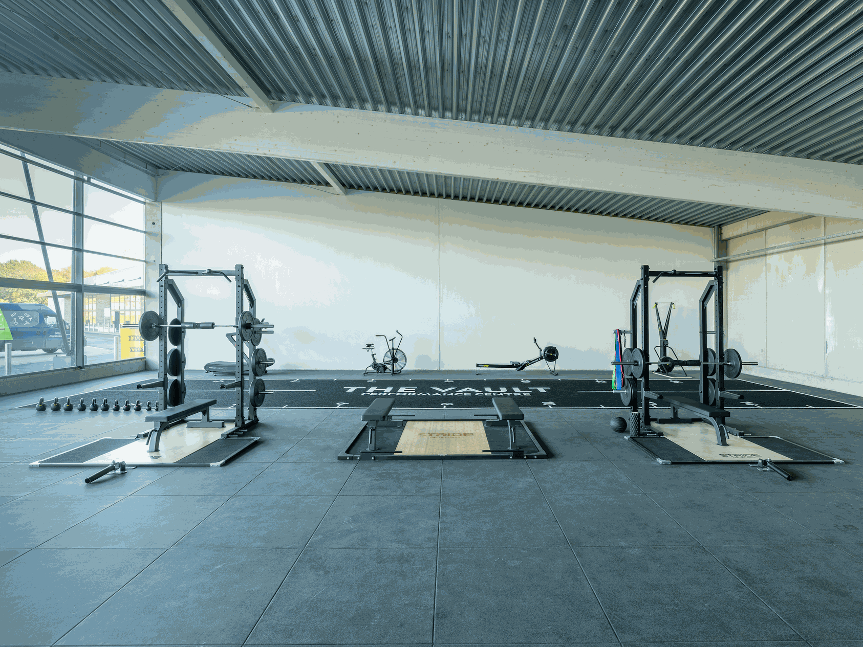 weight training and cardio workout machines in gym front view